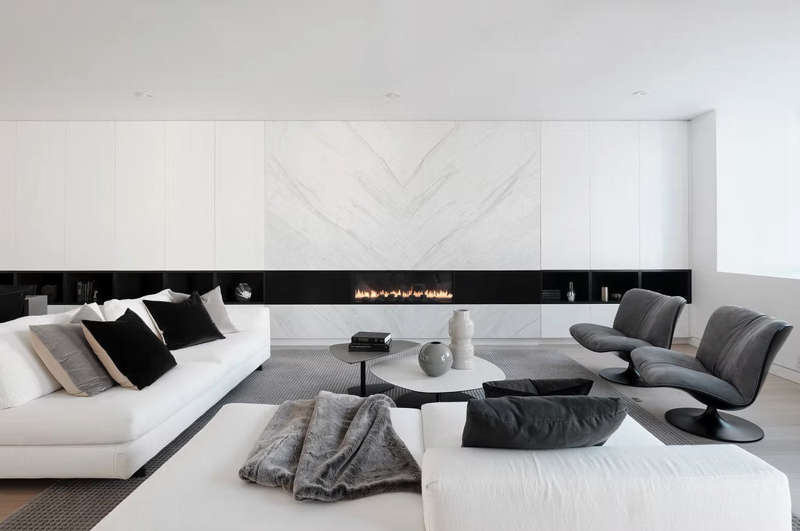 Living room with marble fireplace and white sofas