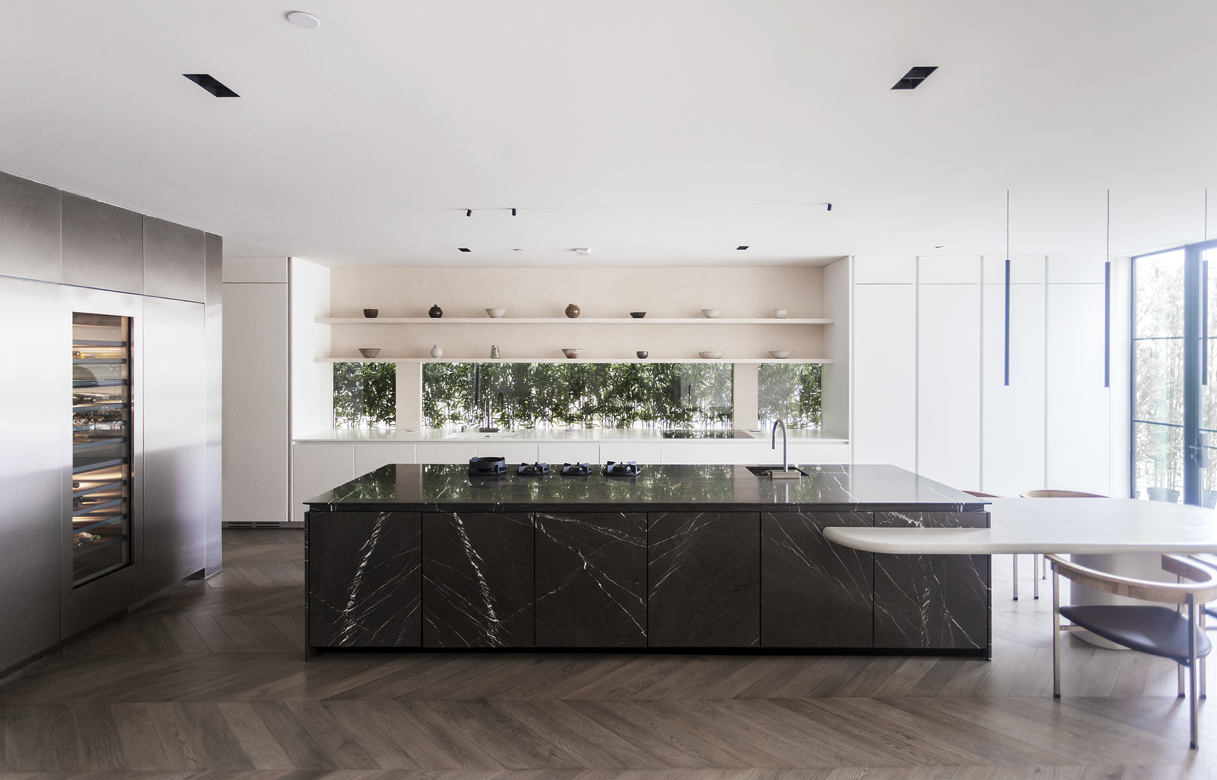 Kitchen with dark marble island and herringbone floor