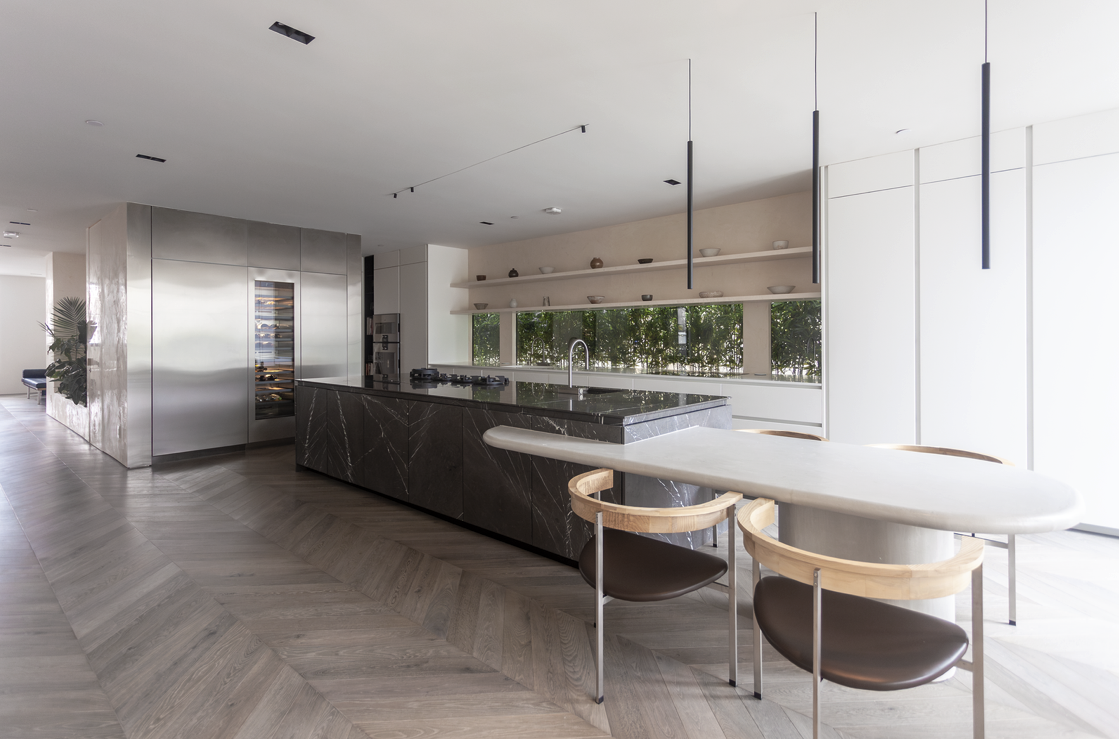 Minimal kitchen with marble island, stainless steel and pendant lighting